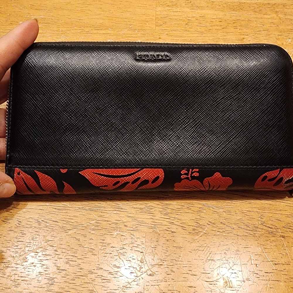 Prada Saffiano leather wallet featuring a distinct red hibiscus floral print